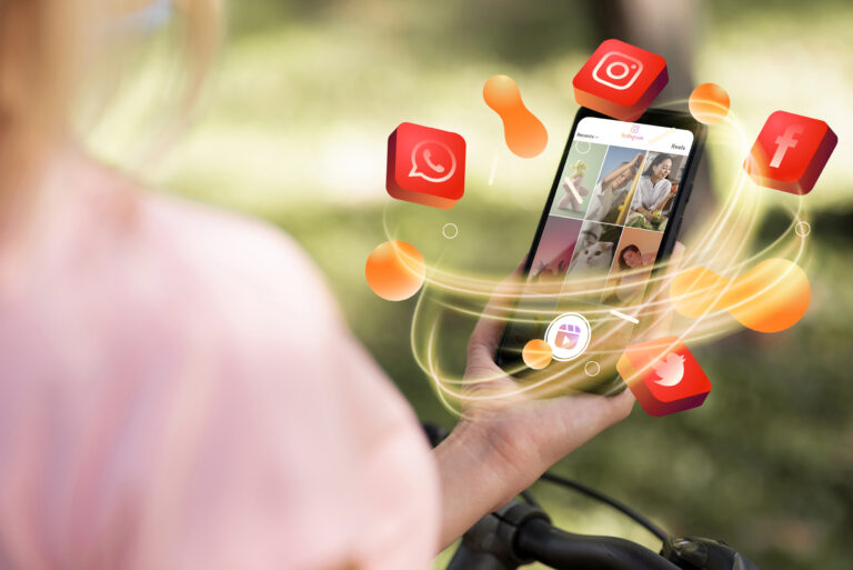 Hand holding phone and surrounded by Off-page SEO social media icons
